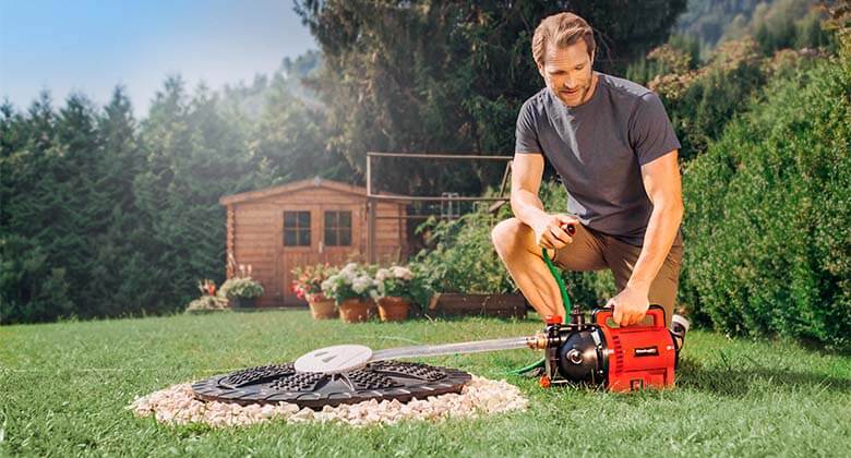 man using a garden pump